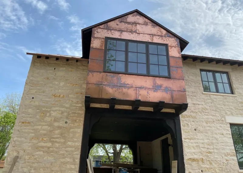 Copper metal panel facade on a stone building for Roof Repair in Bel Air North